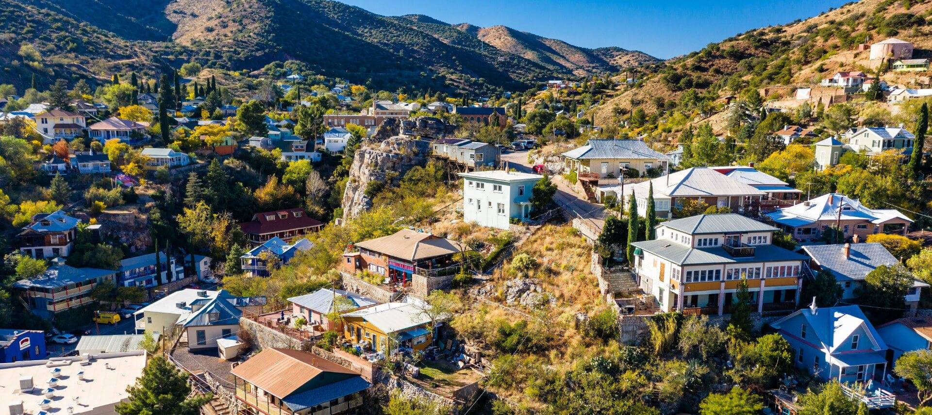 Overhead view of a small town in a valley with buildings and homes peppered throughout